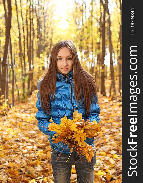 Young teenager girl in the autumn forest