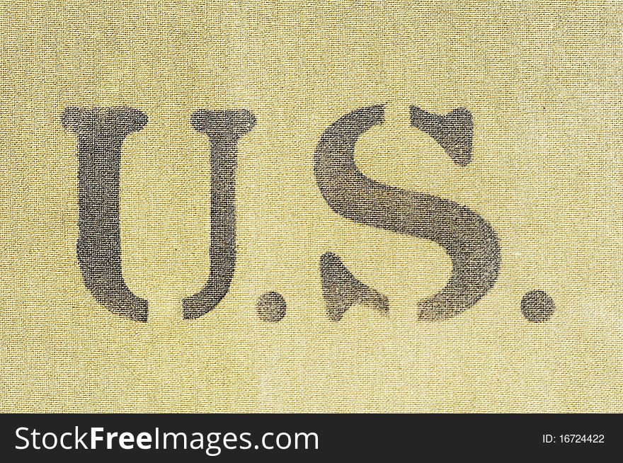 The letters US printed on burlap. The letters US printed on burlap.