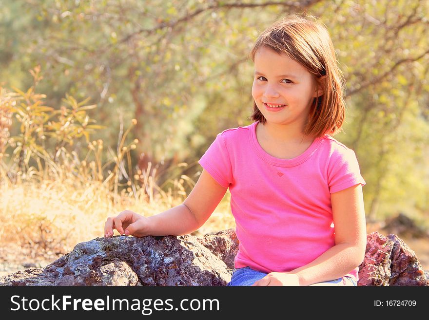 Young Sitting On Rocks