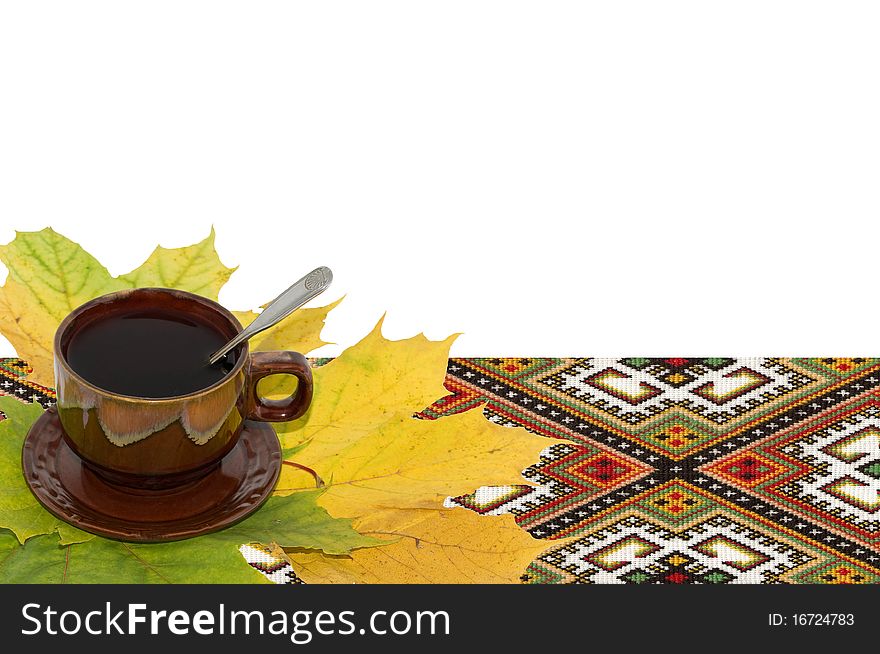 Still-life from a cup of tea and yellow autumn leaves