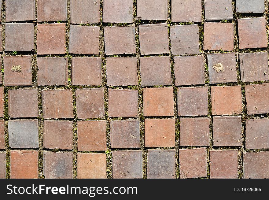 Closeup of square red clay brickwork. These bricks were originally on a walkway. Closeup of square red clay brickwork. These bricks were originally on a walkway.