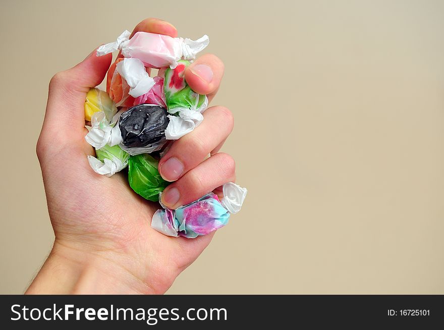 A pile of multicolored saltwater taffy candy on a white cloth.