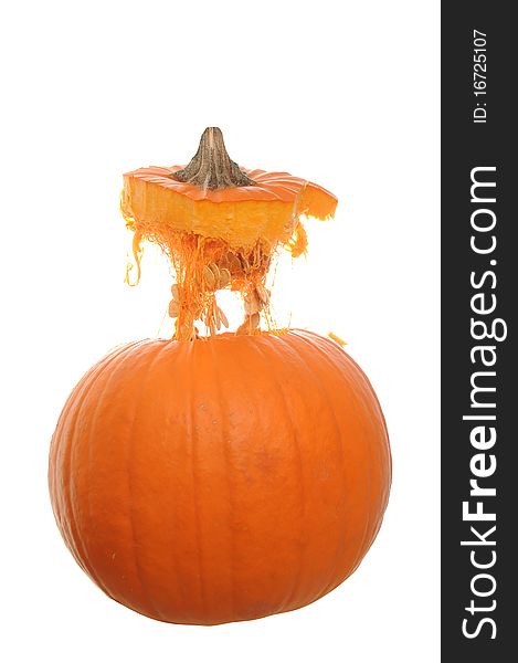 Orange pumpkin isolated on a white background with its top floating above it in mid air. Orange pumpkin isolated on a white background with its top floating above it in mid air.