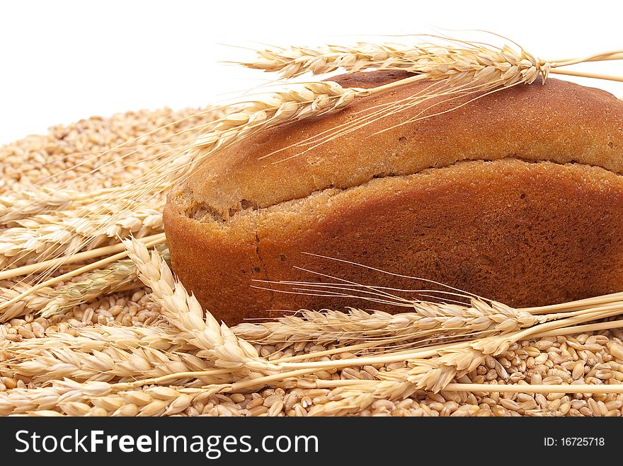 Bread with wheat and ears on white