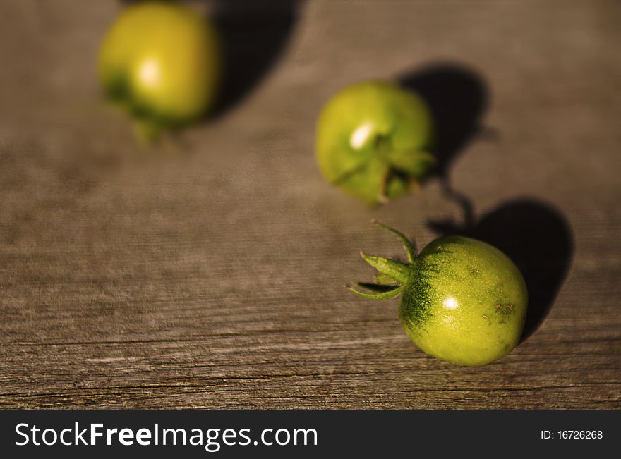 Three round fruit placed on wood texture. Three round fruit placed on wood texture