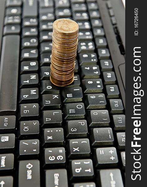 Coins on a black computer keyboard. Coins on a black computer keyboard