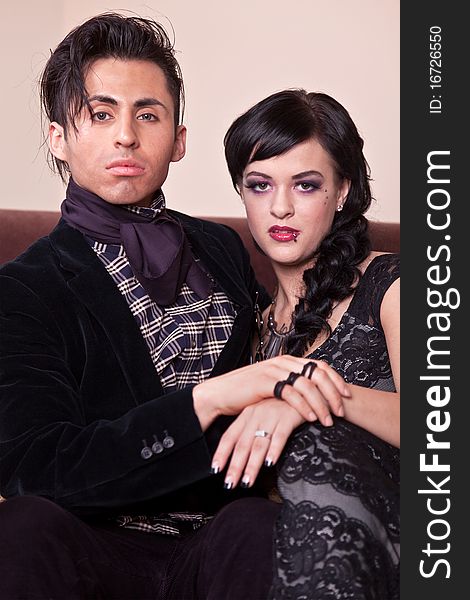 Elegant young couple posing on a sofa. Elegant young couple posing on a sofa.