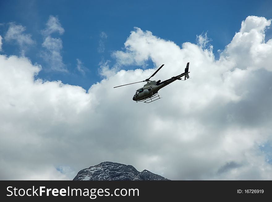 Mountain rescue helicopter above Marmolada slopes. Mountain rescue helicopter above Marmolada slopes.