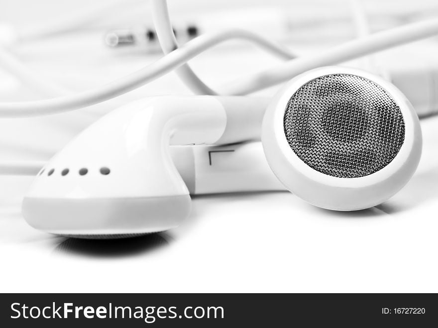 Macro close up of white earphones - very shallow depth field. Macro close up of white earphones - very shallow depth field