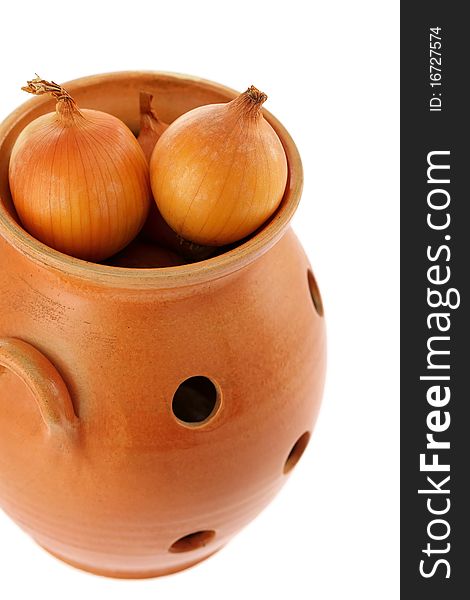 Onion in a ceramic pot. Isolated on a white background