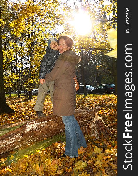 Happy mother and son in the autumn park. Happy mother and son in the autumn park