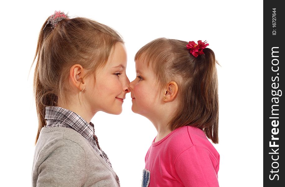 Two Young Sisters Posing Together In A Studio