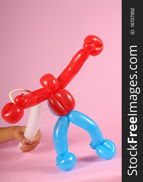 Twisted balloon man isolated on  pink