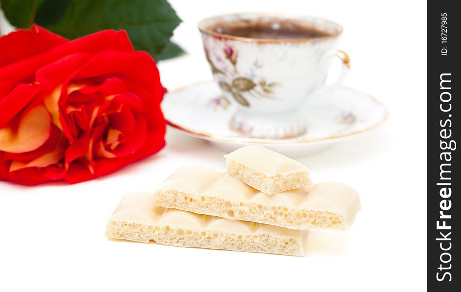 White chocolate, a cup of coffee, rose isolated on white