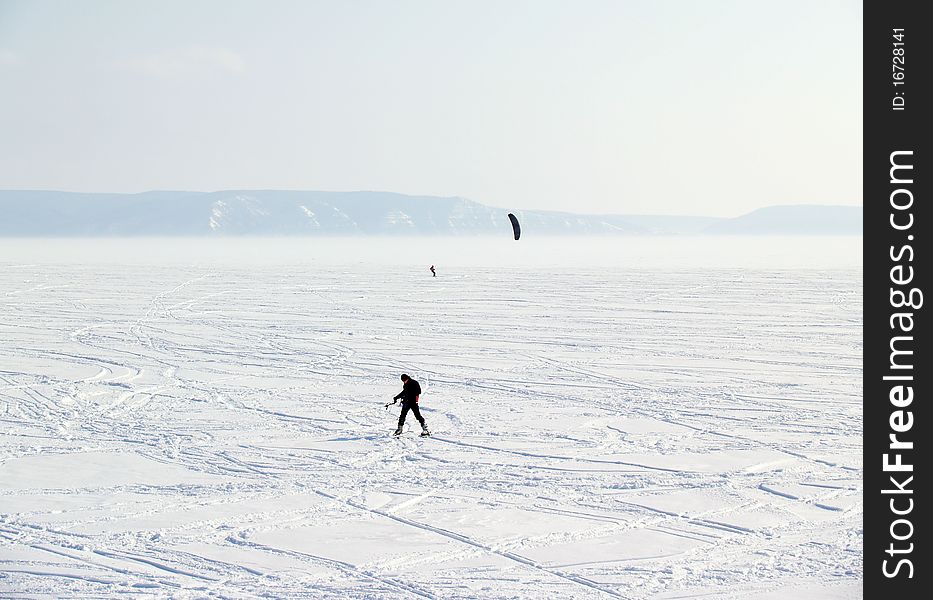 A view of Volga River in winter, Russia. There is a man with parachute on the river.