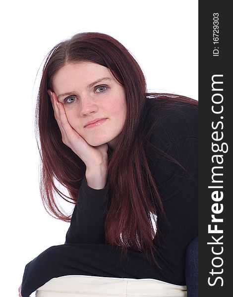 Young woman in studio resting chin on hand. Young woman in studio resting chin on hand