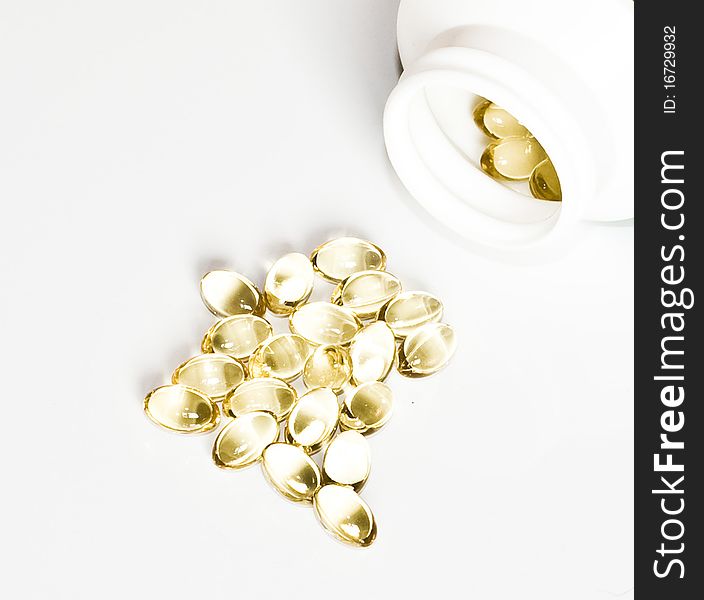 Yellow pills and a package of pills isolated on white