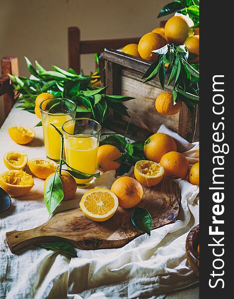 Table With Box Of Fresh Orange With Orange Tree Branch And Fresh Orange Juice