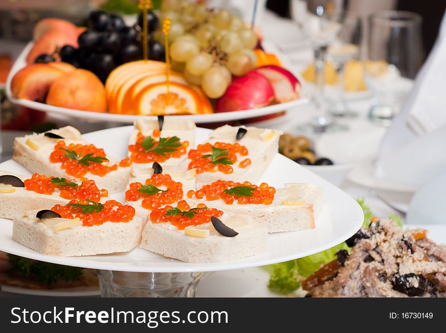 With different fruits and caviar sandwiches. With different fruits and caviar sandwiches
