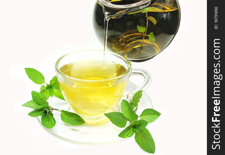 Pouring herbal tea with mint extract