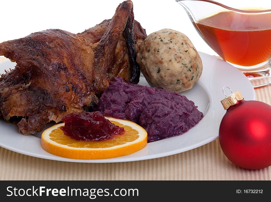 Roasted duck at christmas, decorated with dumpling and red cabbage