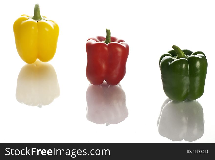 Three colourful peppers on the white background