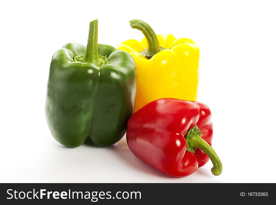 Pattern of many colourful peppers on the white background