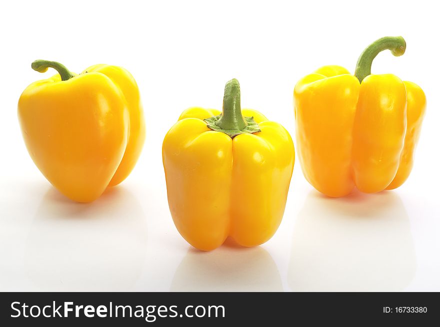 Pattern of many colourful peppers on the white background