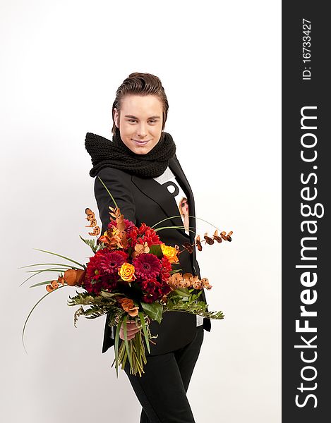Studio shot of teenager boy holding a bunch of flowers on white background. Studio shot of teenager boy holding a bunch of flowers on white background.