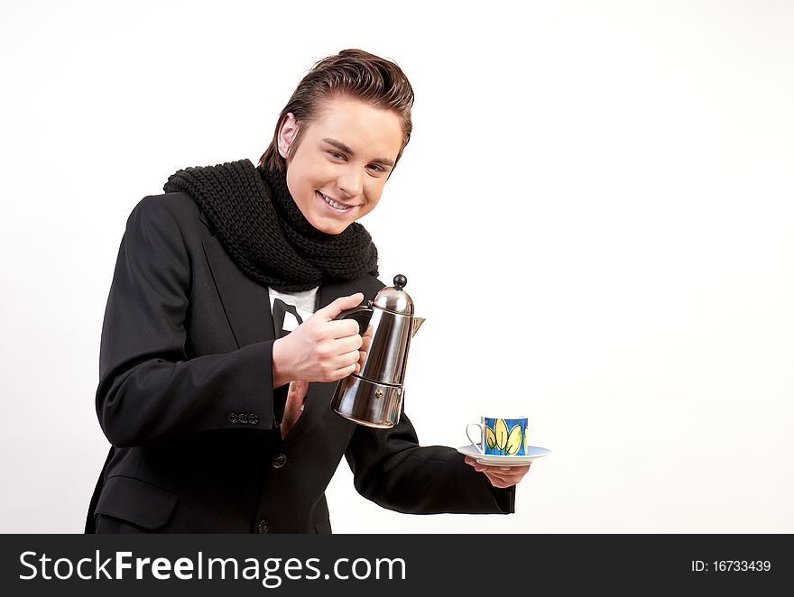 Teenager holding a coffee maker and a coffe cup on white background. Teenager holding a coffee maker and a coffe cup on white background.