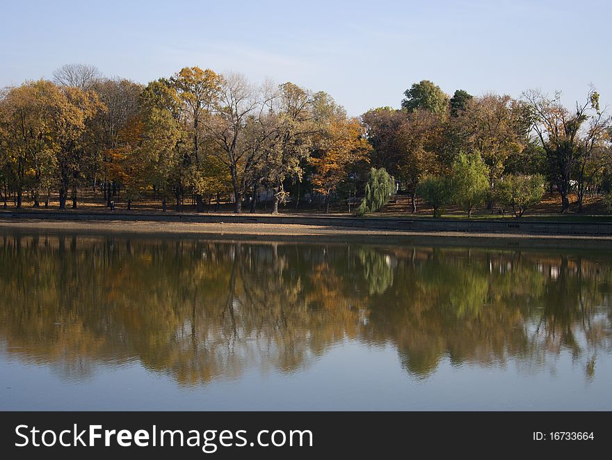 Autumn landscape with trees reflected in the lake. Autumn landscape with trees reflected in the lake