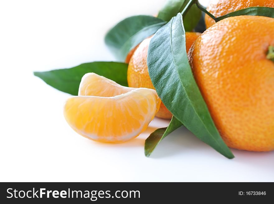 Juicy organic tangerines with leaves isolated on white background