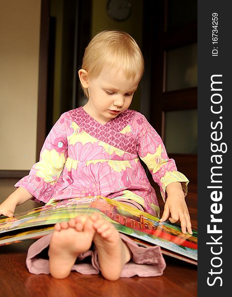 2 years old girl reading or browse through pop-up book. 2 years old girl reading or browse through pop-up book.