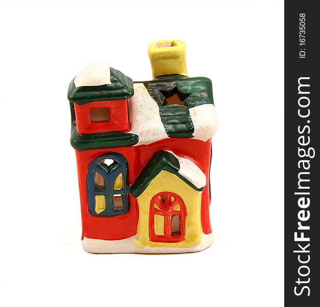 Ceramic candlestick a multi-colored small house with pipe and cheerful windows. Ceramic candlestick a multi-colored small house with pipe and cheerful windows