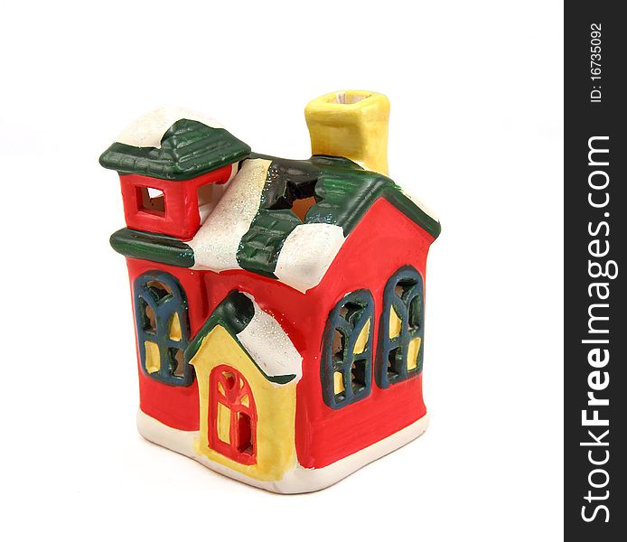 Ceramic candlestick a multi-colored small house with pipe and cheerful windows. Ceramic candlestick a multi-colored small house with pipe and cheerful windows