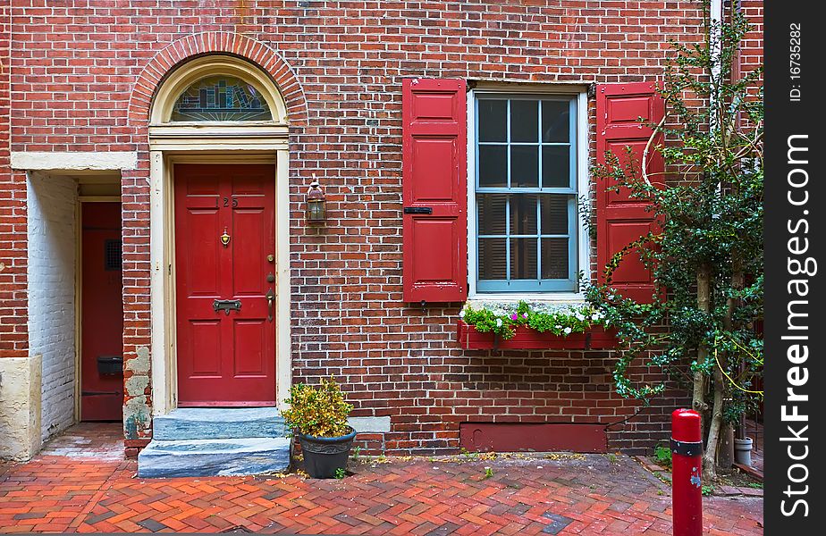 Colorful Red Door And Brick Wall