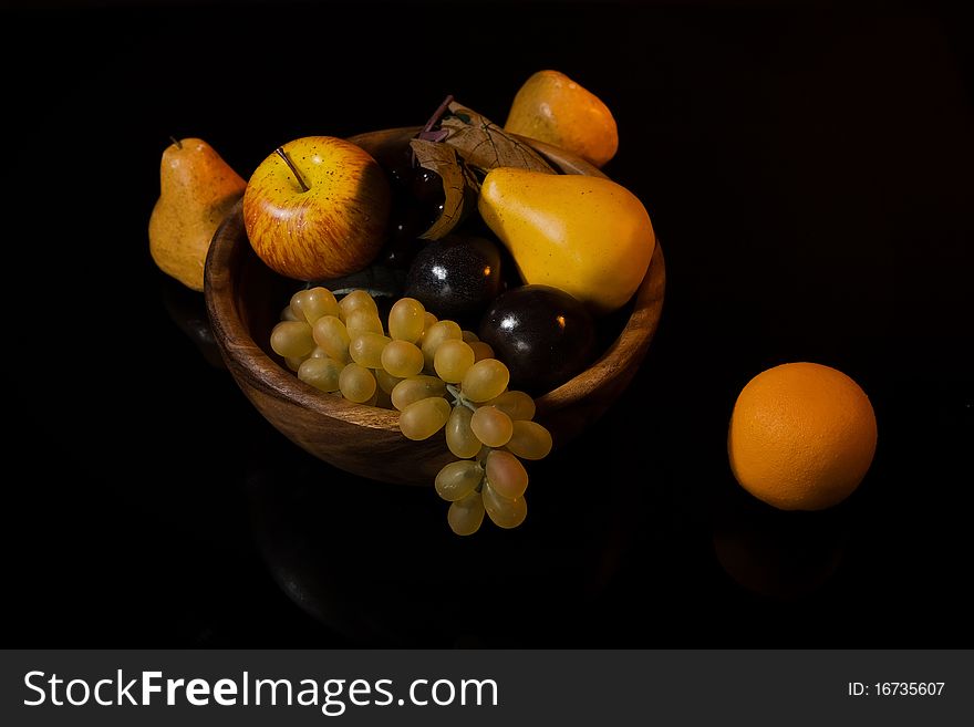 Picture of a still-life with fruit in a wooden dish