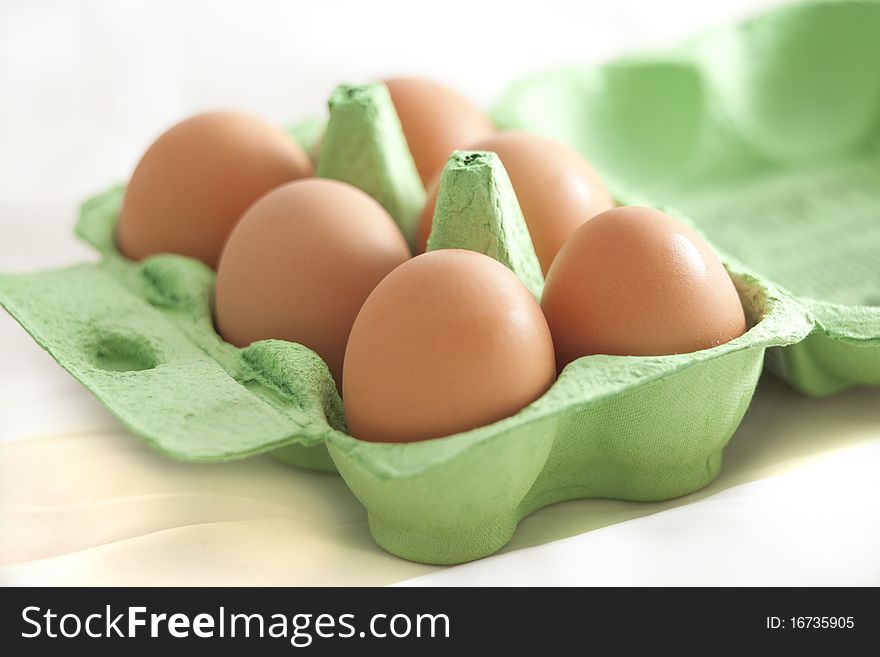 Six eggs in a carton isolated on white. Six eggs in a carton isolated on white.