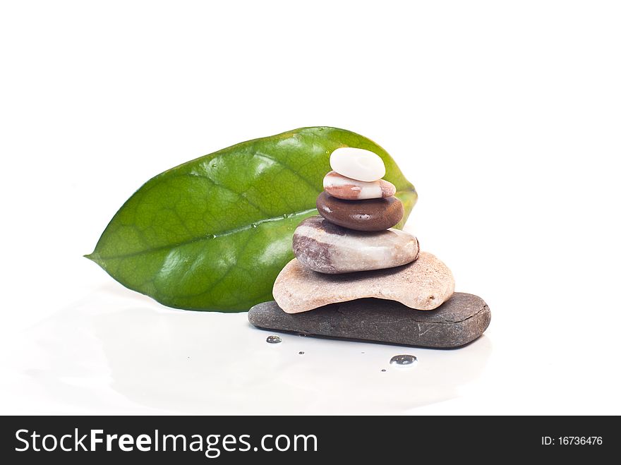 Green leaves and pyramid with stones. Green leaves and pyramid with stones