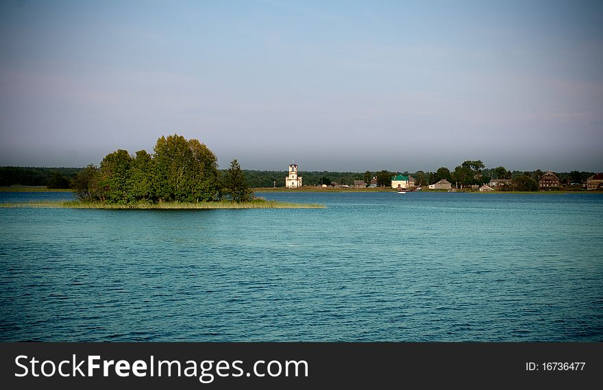 Beautiful tranquil landscape with old chapel on the horizon