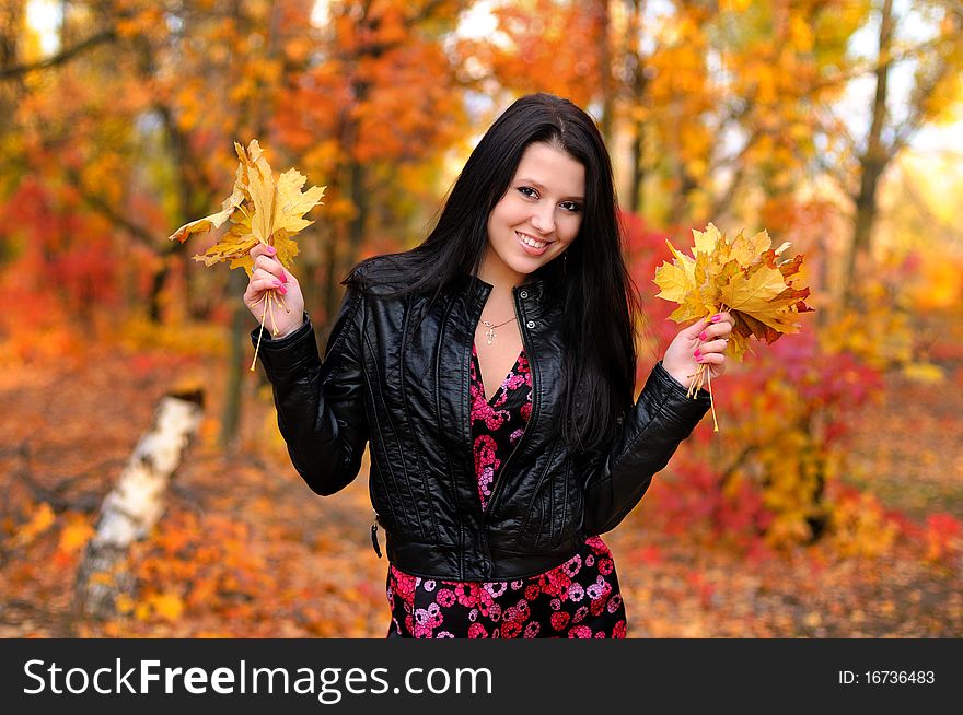 The girl brunette in autumn wood
