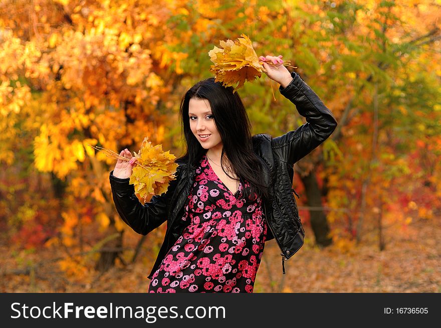 The girl brunette in autumn wood