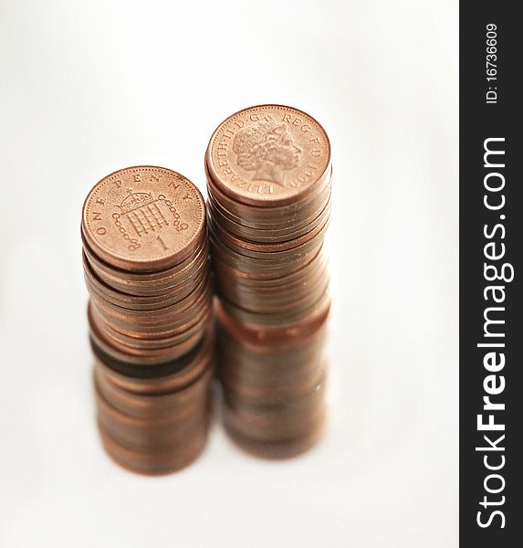 Two piles of British pennies isolated on white. Two piles of British pennies isolated on white.