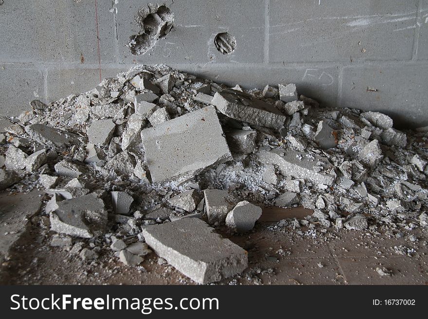 Photo of a pile of cement rubble laying in an abandon building