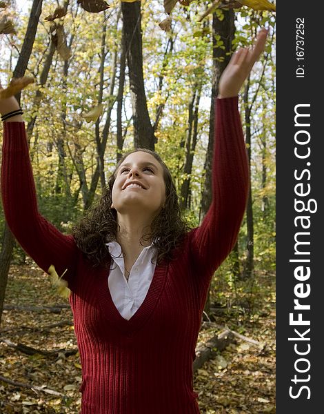 Young Woman Tossing Leaves