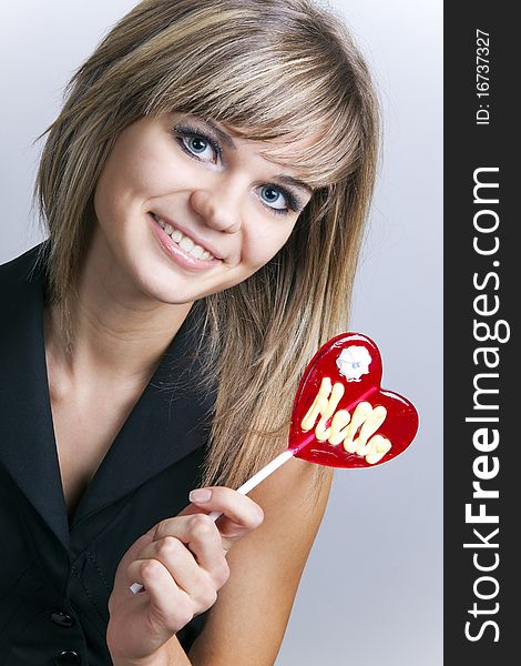 Portrait of an attractive girl with a lollipop
