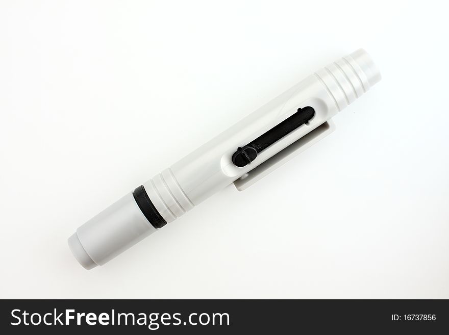 Lens pen for clean up your lens. On white paper. Lens pen for clean up your lens. On white paper.