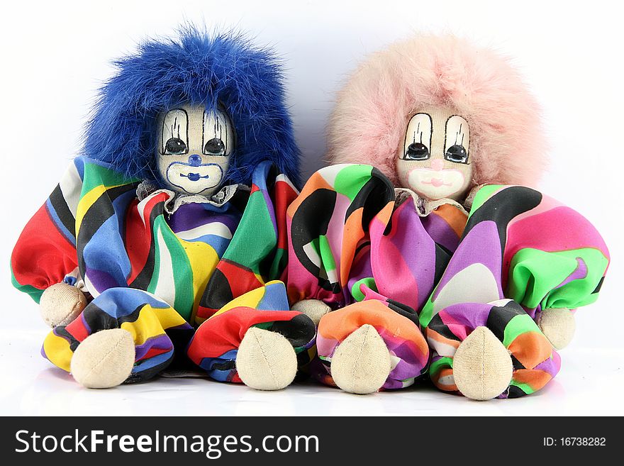 The Two Clown dolls sitting on a white background.