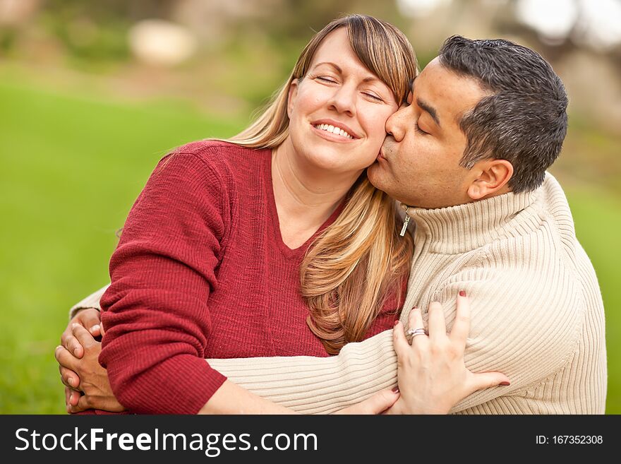 Attractive Mixed Race Couple Portrait Outdoors in the Park. Attractive Mixed Race Couple Portrait Outdoors in the Park.