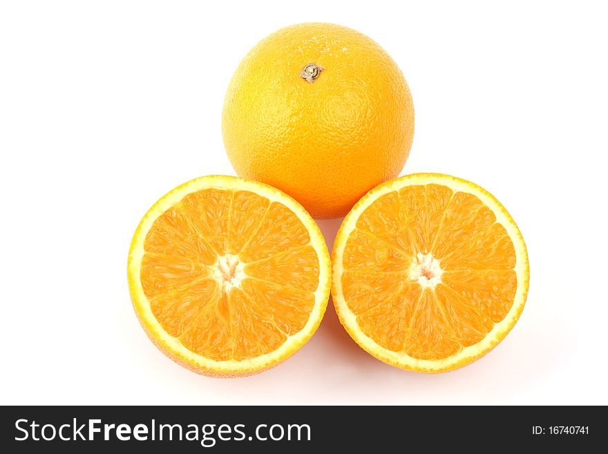 Close up an orange and two half a tablet of orange on a white background. Close up an orange and two half a tablet of orange on a white background